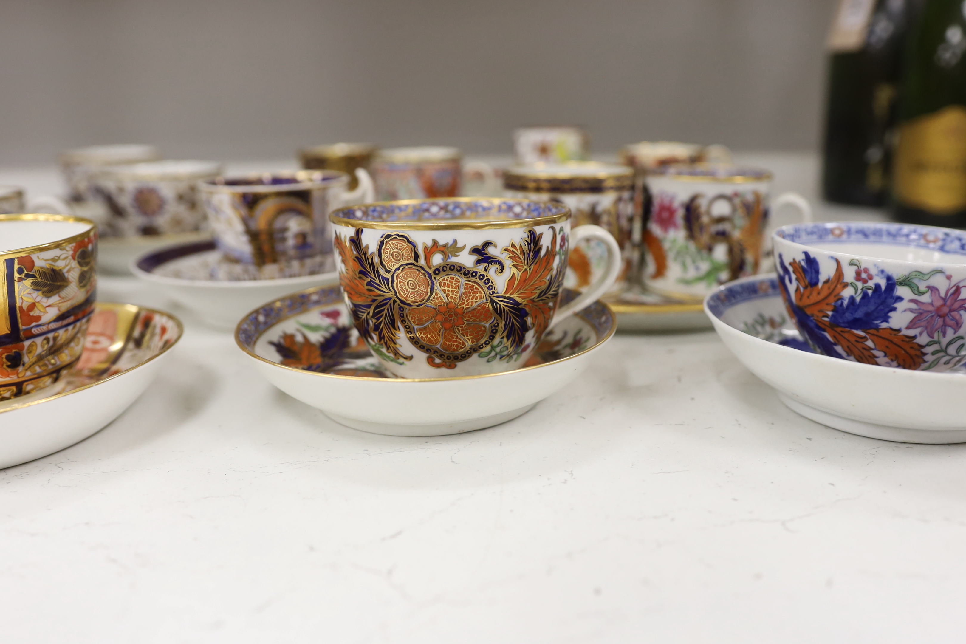 Six mixed English 1800-1820 porcelain cabinet cups and saucers, three similar coffee cans and saucers, a matching spoon stand and two coffee cans, a saucer dish, coffee can plus saucer and a tea bowl and matching saucer